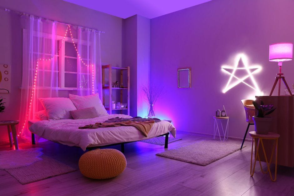 Bedroom lit with multi-color smart LED strips, neon, and ambient RGB lighting